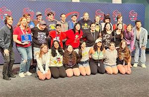Students post with celebrities at Disney World.